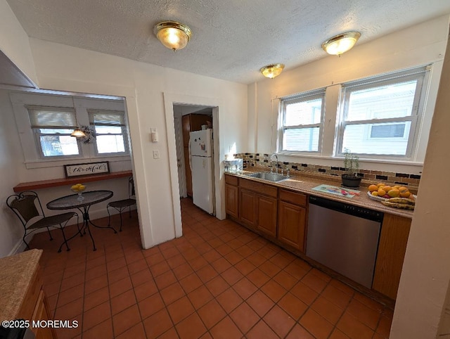 619 Leland Ave, Plainfield, NJ 07062 - kitchen with stainless steel dishwasher, a sink, freestanding refrigerator, a textured ceiling, and plenty of natural light