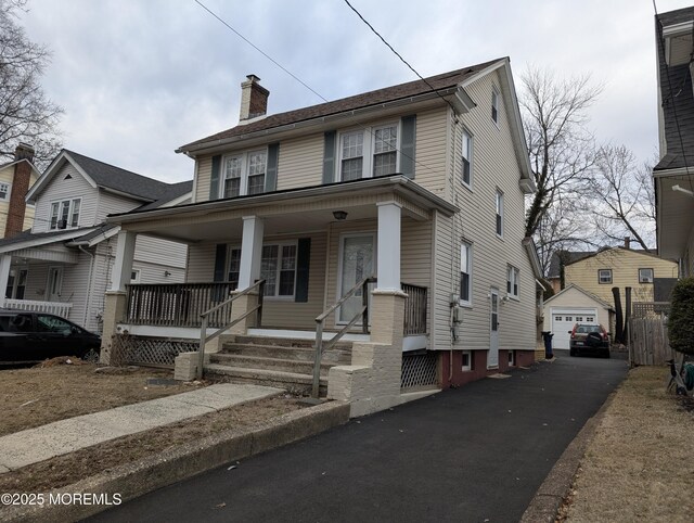 619 Leland Ave, Plainfield, NJ 07062 - view of front of property featuring a garage, covered porch, a chimney, and an outbuilding