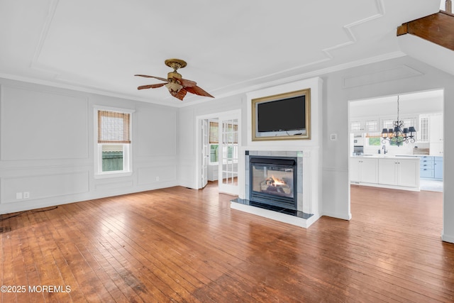 208 Cedar St, Lakehurst, NJ 08733 - unfurnished living room with healthy amount of natural light, a ceiling fan, hardwood / wood-style floors, a tiled fireplace, and ornamental molding