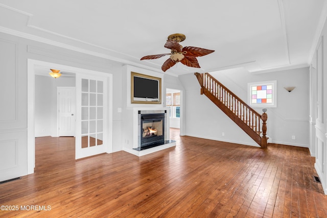 208 Cedar St, Lakehurst, NJ 08733 - unfurnished living room featuring stairway, a ceiling fan, hardwood / wood-style floors, ornamental molding, and a multi sided fireplace