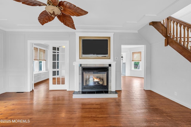 208 Cedar St, Lakehurst, NJ 08733 - unfurnished living room featuring ceiling fan, stairway, wood-type flooring, a glass covered fireplace, and baseboards