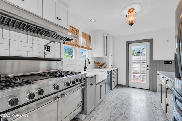 208 Cedar St, Lakehurst, NJ 08733 - kitchen with under cabinet range hood, healthy amount of natural light, appliances with stainless steel finishes, decorative backsplash, and recessed lighting