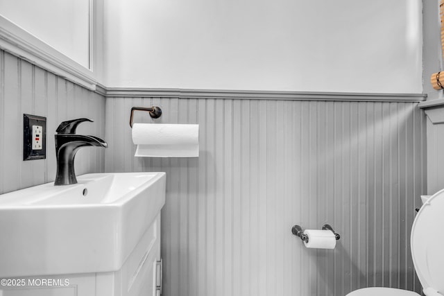 208 Cedar St, Lakehurst, NJ 08733 - half bath with a sink, a wainscoted wall, and toilet