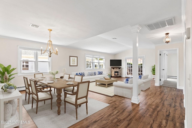 40 Prince Charles Dr, Toms River, NJ 08757 - dining room with wood finished floors, a chandelier, baseboard heating, vaulted ceiling, and baseboards