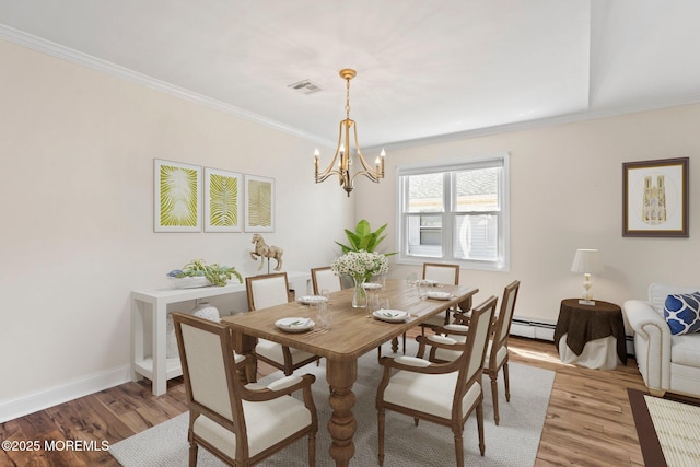 40 Prince Charles Dr, Toms River, NJ 08757 - dining space featuring light wood-style floors, a chandelier, ornamental molding, baseboards, and a baseboard heating unit