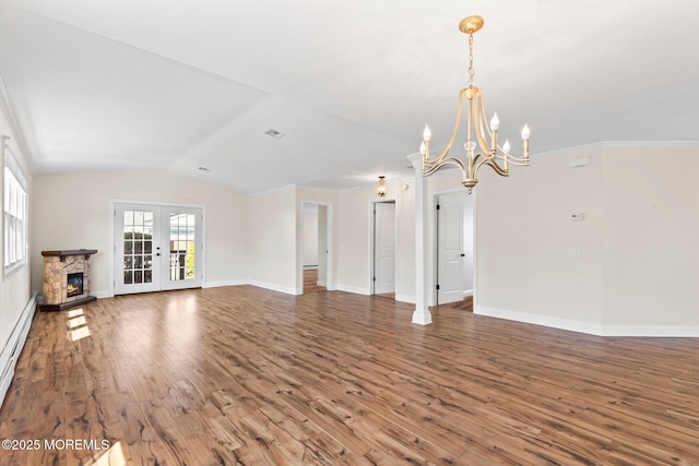 40 Prince Charles Dr, Toms River, NJ 08757 - unfurnished living room with a chandelier, wood finished floors, lofted ceiling, baseboards, and french doors
