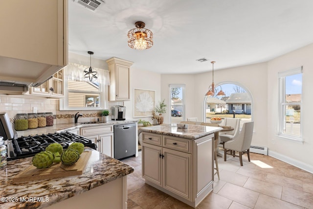 40 Prince Charles Dr, Toms River, NJ 08757 - kitchen featuring dishwasher, a chandelier, a baseboard heating unit, cream cabinetry, and light stone counters