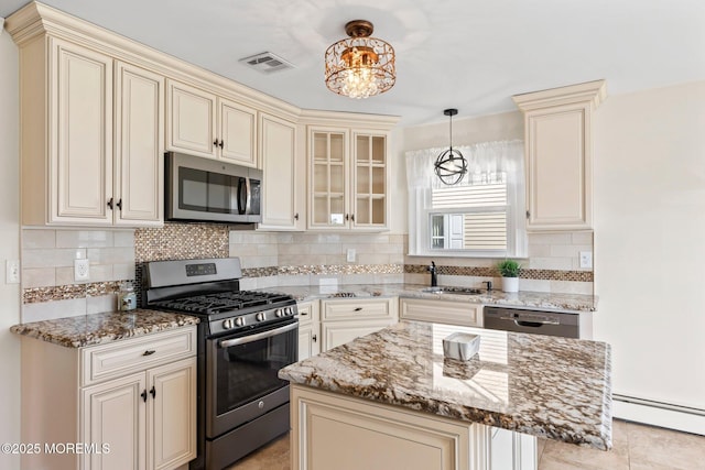 40 Prince Charles Dr, Toms River, NJ 08757 - kitchen with appliances with stainless steel finishes, cream cabinetry, a sink, and baseboard heating