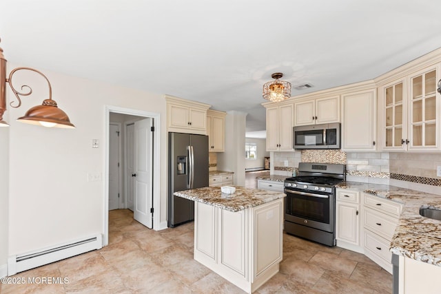 40 Prince Charles Dr, Toms River, NJ 08757 - kitchen featuring stainless steel appliances, baseboard heating, cream cabinets, a center island, and light stone counters