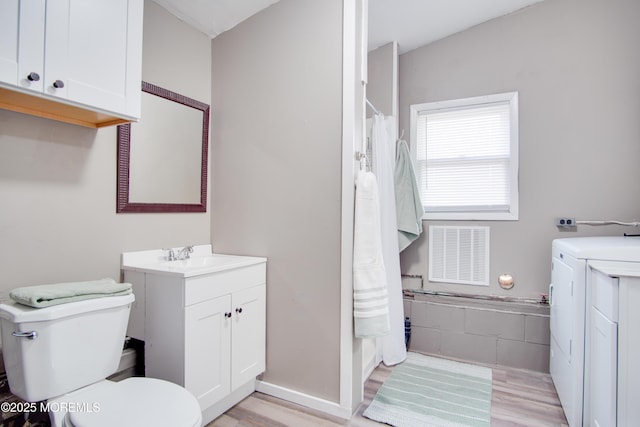 112 Bash Rd, Toms River, NJ 08753 - full bath with washer and dryer, toilet, vanity, wood finished floors, and a shower with shower curtain