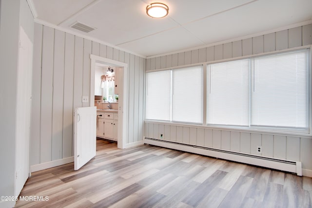112 Bash Rd, Toms River, NJ 08753 - empty room with a baseboard heating unit, light wood-style flooring, a sink, and baseboards