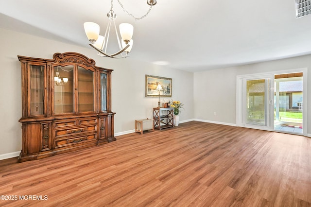 47 Wild Turkey Way Unit E, Manalapan, NJ 07726 - spare room with a chandelier, light wood-type flooring, and baseboards