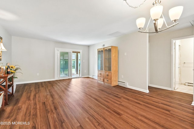 47 Wild Turkey Way Unit E, Manalapan, NJ 07726 - unfurnished living room featuring a chandelier, wood finished floors, a baseboard radiator, and baseboards