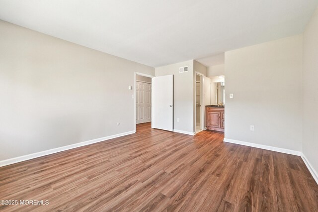 47 Wild Turkey Way Unit E, Manalapan, NJ 07726 - unfurnished bedroom featuring baseboards and wood finished floors