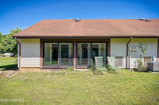 47 Wild Turkey Way Unit E, Manalapan, NJ 07726 - back of property with a lawn, a shingled roof, and central air condition unit