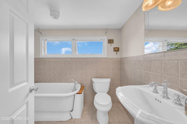 773 Princeton Ave, Brick, NJ 08724 - bathroom with a sink, a freestanding tub, toilet, tile walls, and tile patterned floors
