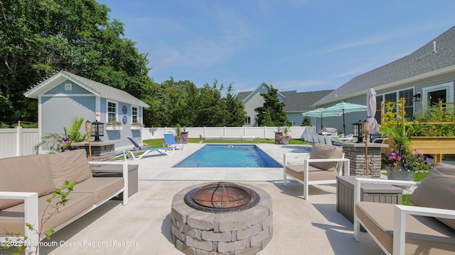 24 Woodview Ln, Cape May Court House, NJ 08210 - view of swimming pool with a patio area, an outdoor living space with a fire pit, a fenced backyard, and an outdoor structure