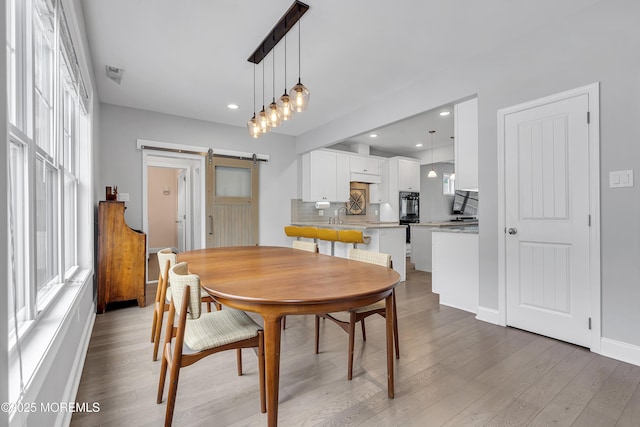 24 Woodview Ln, Cape May Court House, NJ 08210 - dining room with a barn door, light wood-style flooring, baseboards, and recessed lighting