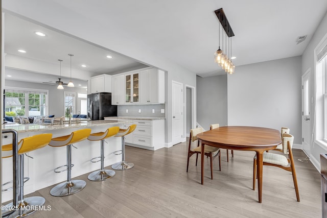 24 Woodview Ln, Cape May Court House, NJ 08210 - kitchen with freestanding refrigerator, glass insert cabinets, light wood-type flooring, white cabinets, and recessed lighting