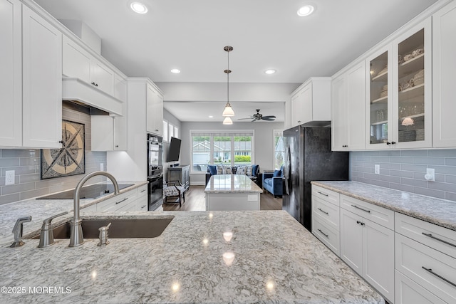 24 Woodview Ln, Cape May Court House, NJ 08210 - kitchen with recessed lighting, a ceiling fan, white cabinetry, glass insert cabinets, and light stone countertops