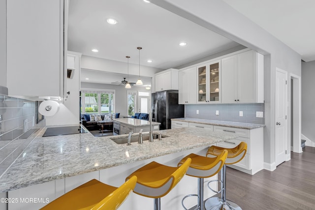 24 Woodview Ln, Cape May Court House, NJ 08210 - kitchen featuring black appliances, a peninsula, glass insert cabinets, white cabinetry, and backsplash