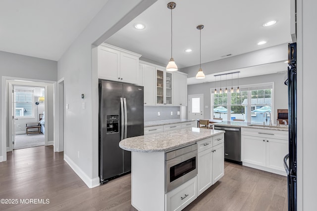 24 Woodview Ln, Cape May Court House, NJ 08210 - kitchen with stainless steel appliances, a center island, tasteful backsplash, glass insert cabinets, and white cabinetry