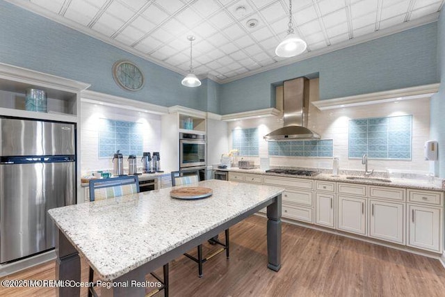 700 Ocean Ave Unit 514, Spring Lake, NJ 07762 - kitchen featuring stainless steel appliances, wall chimney range hood, open shelves, a sink, and a breakfast bar