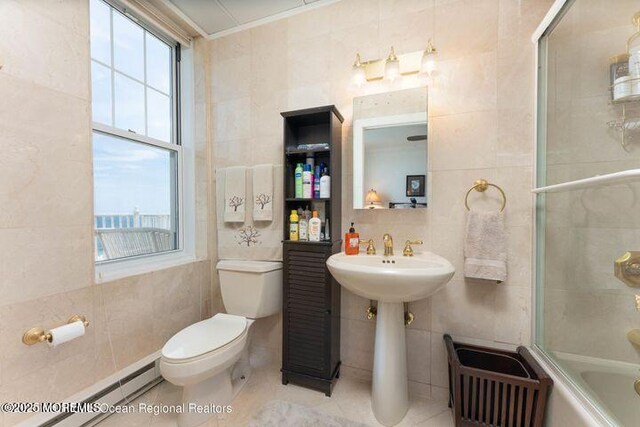 700 Ocean Ave Unit 514, Spring Lake, NJ 07762 - full bath featuring tile walls, baseboard heating, toilet, enclosed tub / shower combo, and a sink