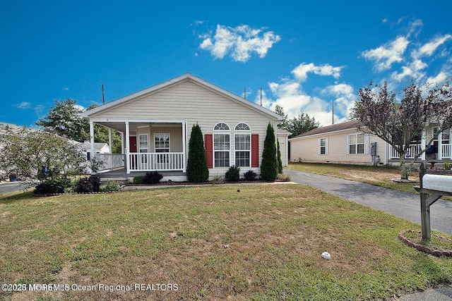 9 Pine Grove Ave, Manahawkin, NJ 08050 - view of front facade featuring covered porch and a front yard
