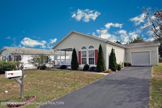 9 Pine Grove Ave, Manahawkin, NJ 08050 - ranch-style house with a porch, driveway, a garage, and a front yard