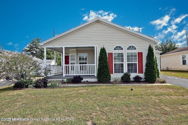 9 Pine Grove Ave, Manahawkin, NJ 08050 - view of front of home with a porch and a front lawn