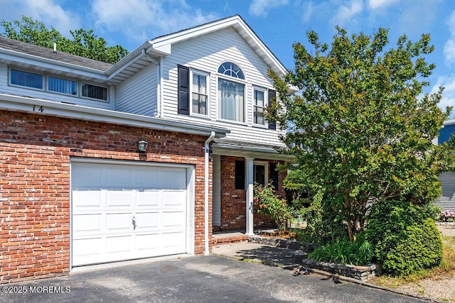 14 Emerald Dr Unit B, Barnegat, NJ 08005 - view of front facade featuring a garage, brick siding, and asphalt driveway