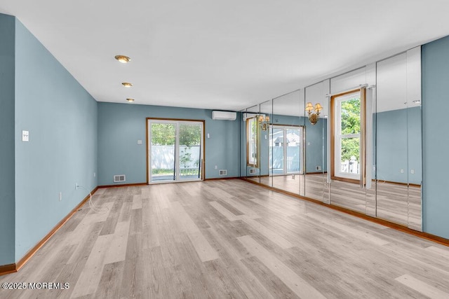 14 Emerald Dr Unit B, Barnegat, NJ 08005 - unfurnished room featuring light wood-style flooring, a wall mounted air conditioner, and baseboards