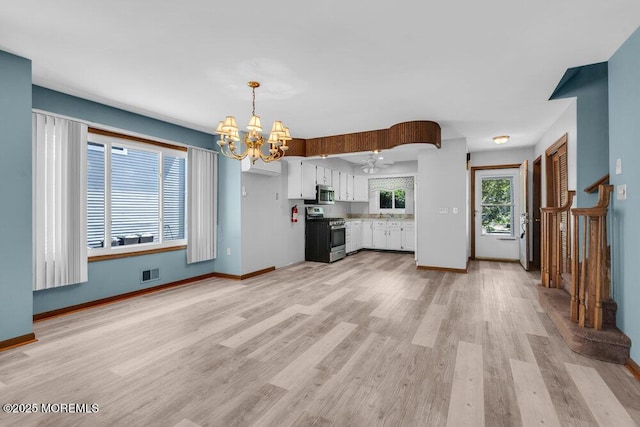 14 Emerald Dr Unit B, Barnegat, NJ 08005 - kitchen with stainless steel appliances, a chandelier, white cabinets, light wood finished floors, and baseboards