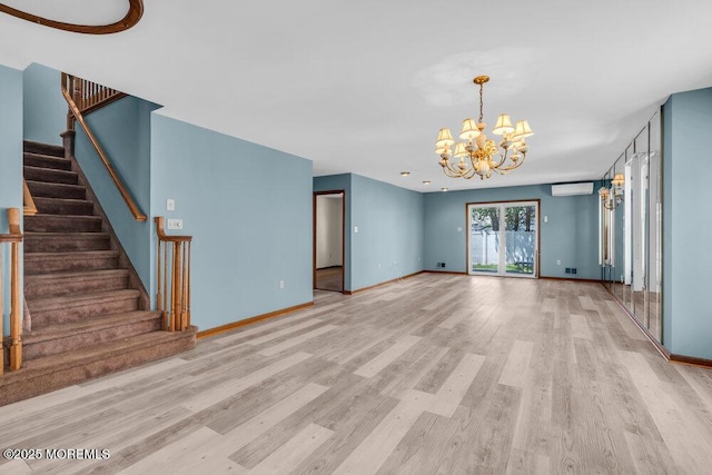 14 Emerald Dr Unit B, Barnegat, NJ 08005 - unfurnished living room with wood finished floors, an AC wall unit, a chandelier, stairway, and baseboards