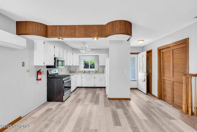 14 Emerald Dr Unit B, Barnegat, NJ 08005 - kitchen with stainless steel appliances, light wood-style flooring, white cabinets, light countertops, and ceiling fan