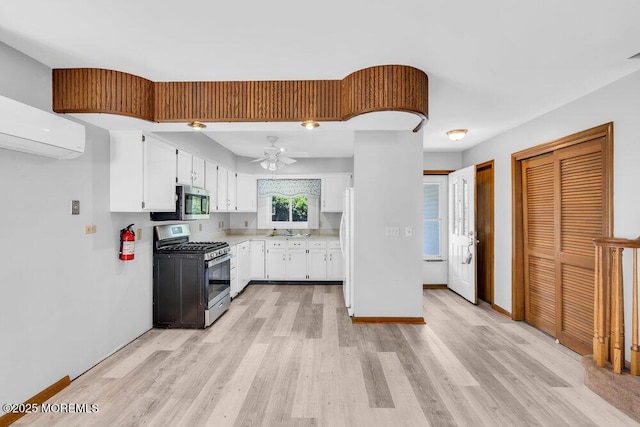 14 Emerald Dr Unit B, Barnegat, NJ 08005 - kitchen with stainless steel appliances, light wood finished floors, white cabinets, light countertops, and a ceiling fan