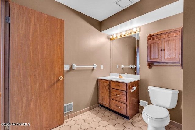 14 Emerald Dr Unit B, Barnegat, NJ 08005 - bathroom featuring vanity, toilet, tile patterned flooring, and baseboards