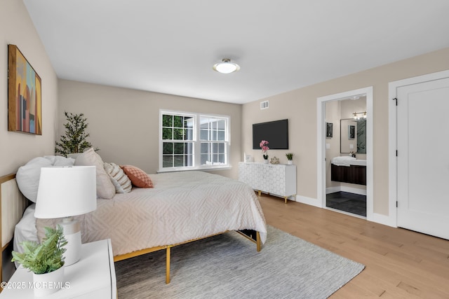 28 Twyford Ln, Manchester, NJ 08759 - bedroom with wood finished floors, ensuite bath, and baseboards
