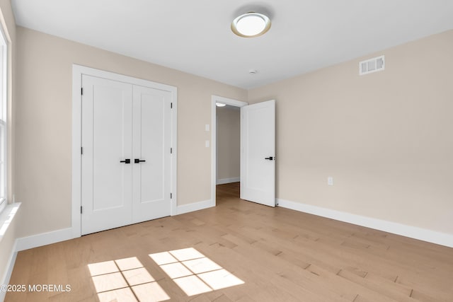 28 Twyford Ln, Manchester, NJ 08759 - unfurnished bedroom with baseboards, light wood-style flooring, and a closet