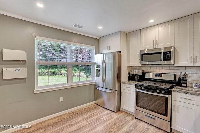 22 Commons Dr, Neptune Township, NJ 07753 - kitchen featuring appliances with stainless steel finishes, light wood-type flooring, backsplash, white cabinetry, and baseboards