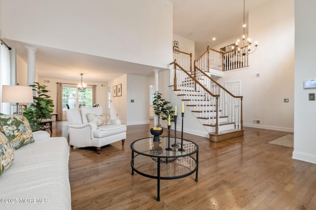 30 Thousand Oaks Ter, Howell, NJ 07731 - living area with a chandelier, wood finished floors, baseboards, stairs, and a high ceiling