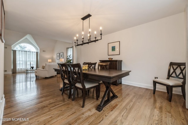30 Thousand Oaks Ter, Howell, NJ 07731 - dining room with light wood finished floors, a chandelier, baseboards, and vaulted ceiling