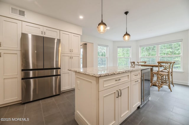 30 Thousand Oaks Ter, Howell, NJ 07731 - kitchen with freestanding refrigerator, beverage cooler, dark tile patterned flooring, hanging light fixtures, and recessed lighting