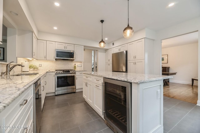30 Thousand Oaks Ter, Howell, NJ 07731 - kitchen featuring stainless steel appliances, wine cooler, dark tile patterned floors, a center island, and a sink
