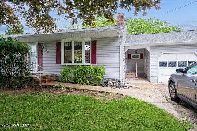 668 Clifton Ave, Toms River, NJ 08753 - view of front of home with a chimney, a garage, and a front yard