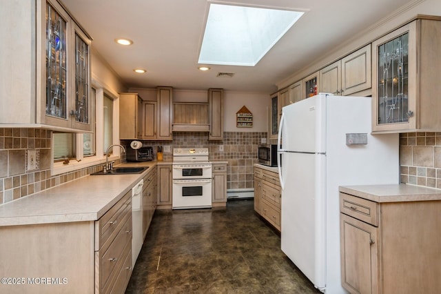 668 Clifton Ave, Toms River, NJ 08753 - kitchen with white appliances, a sink, tasteful backsplash, light countertops, and a skylight
