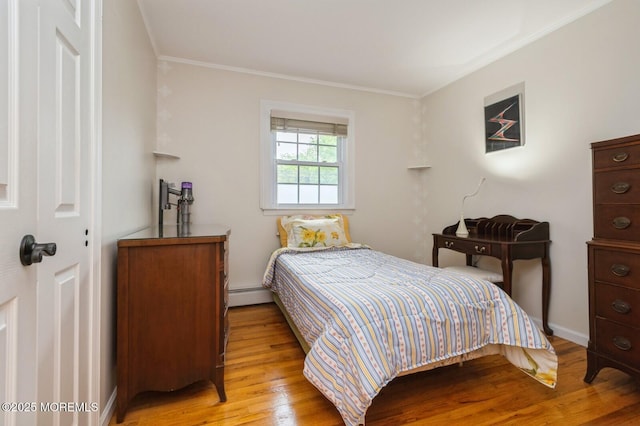 668 Clifton Ave, Toms River, NJ 08753 - bedroom with baseboard heating, ornamental molding, light wood-style flooring, and baseboards