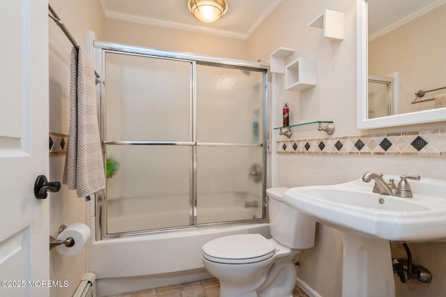 668 Clifton Ave, Toms River, NJ 08753 - full bathroom featuring shower / bath combination with glass door, toilet, ornamental molding, tile walls, and a sink