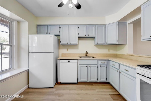 48 Scarborough Ct Unit 7, Freehold, NJ 07728 - kitchen with white appliances, a sink, ceiling fan, light countertops, and light wood-type flooring